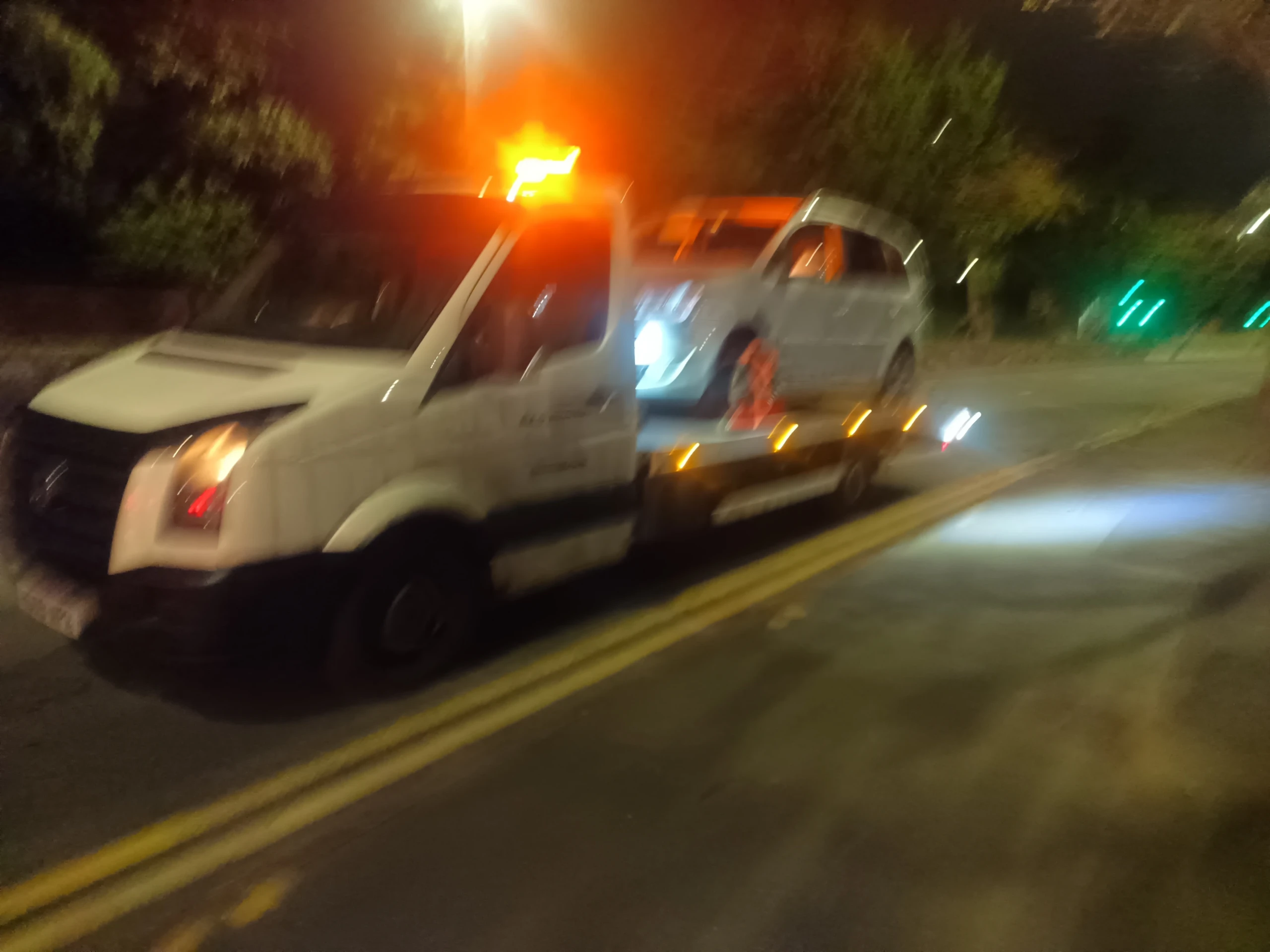 AAD recovery truck with amber beacons attending a night-time emergency breakdown in Birmingham